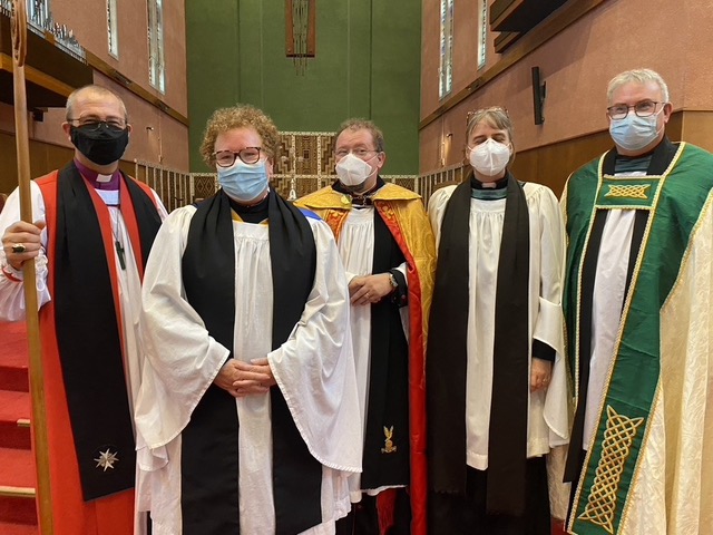 Photo of Jenny Chalmers with Bishop Hedge and clergy